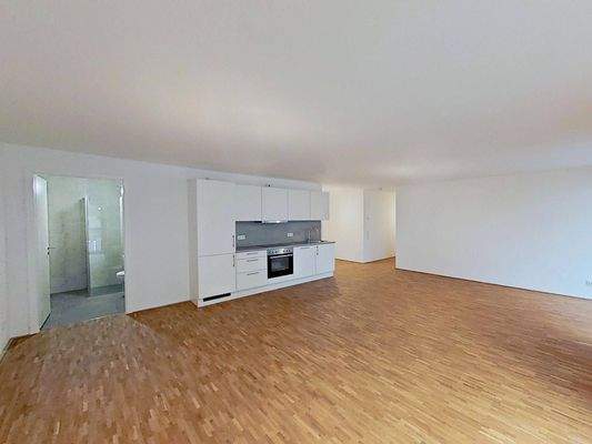 Ansicht IV: Wohn- und Esszimmer mit offenem Küchenbereich