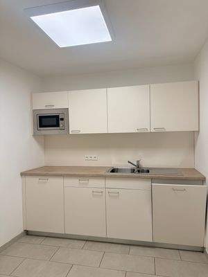 Küche mit Mikrowelle, Spülmaschine, Kühlschrank