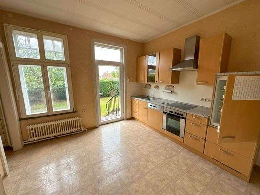 Küche mit Einbauküche und Zugang zum Garten