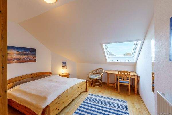 Schlafzimmer mit Doppelbett, Dachfenster, Blick zur Ostsee