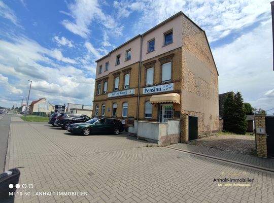 seitliche Hausansicht mit Parkplatz