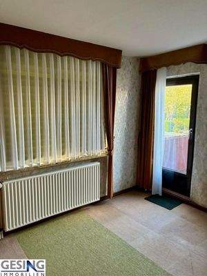 Zimmer im Obergeschosss mit Zugang zum Balkon 