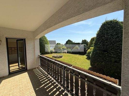 Überdachte Terrasse mit Blick in den Vorgarten und Zugang zur Küche und Wintergarten
