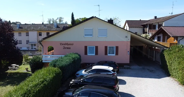 Hausfront mit dem hauseigenen Parkplatz