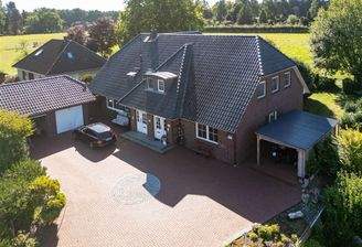 Ansicht Einfahrt mit Doppelgarage und Carport 