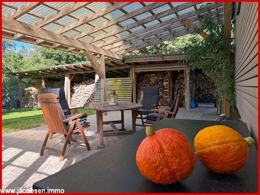 überdachte Terrasse und Holzlager