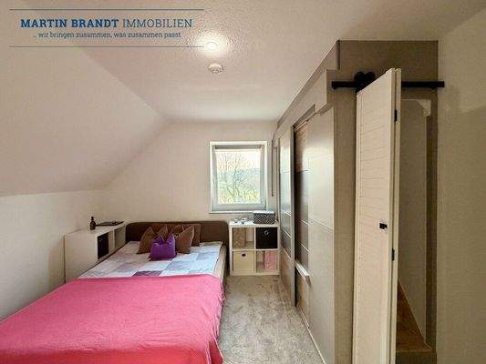 Schlafzimmer mit Treppe zum Dachboden