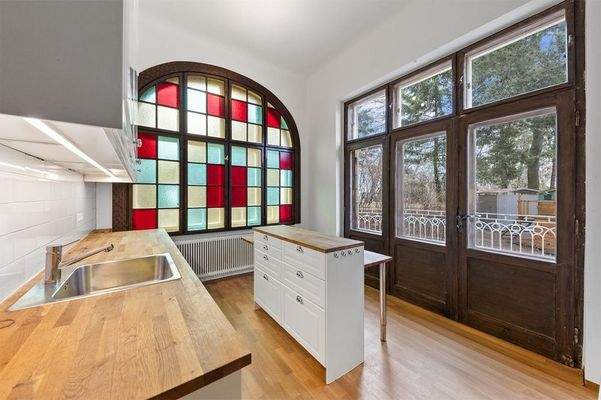 Die charmante Küche mit farbigen Bleiglas-Fenstern