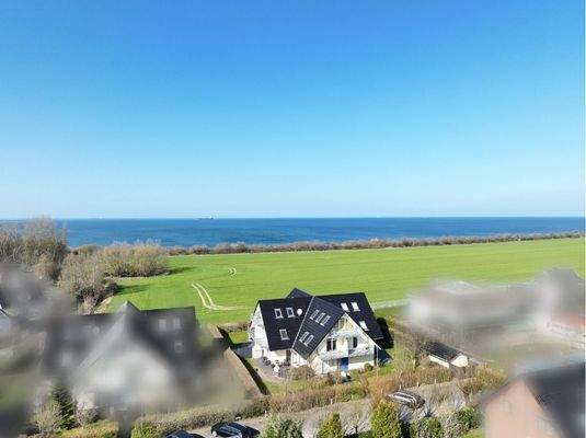 Luftbild aus südwestlicher Richtung mit Blick auf Haus, Grundstück und die Ostsee im Hintergrund